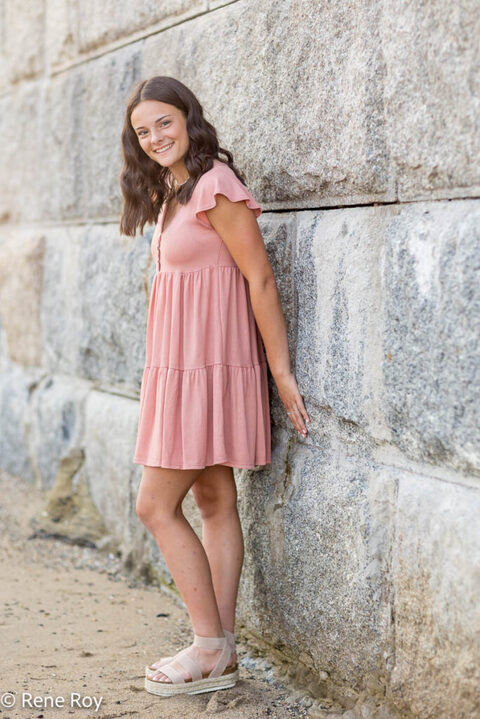 young woman leaning on wall